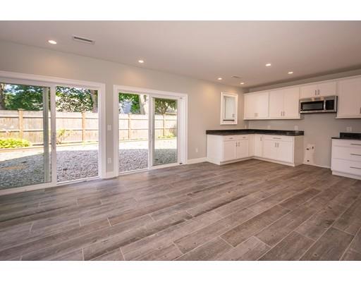 16 Gannett Road Scituate, MA 02066 - Photo 33 of 42 a kitchen with stainless steel appliances granite countertop a refrigerator a sink dishwasher a stove and a large island with wooden floor
