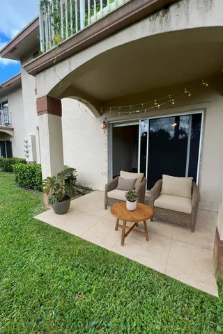 a building outdoor space with patio furniture and garden