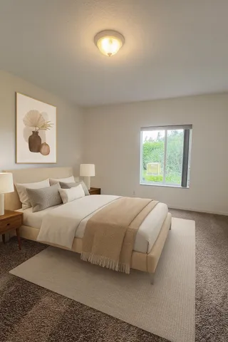 a bedroom with bed and a window