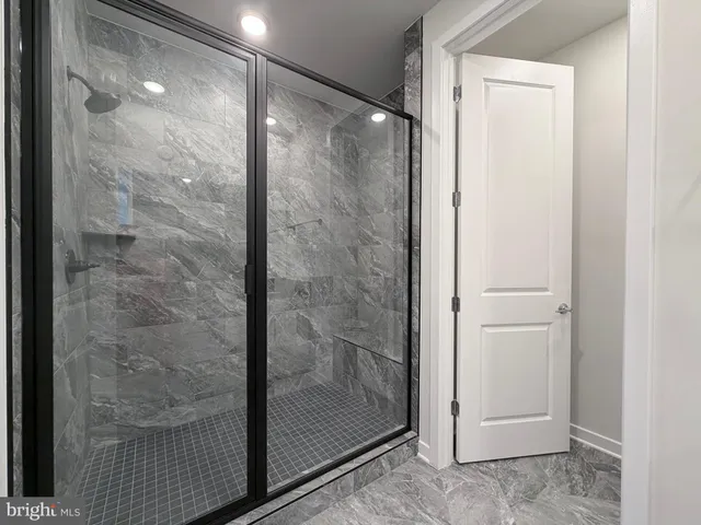 a bathroom with a glass shower door