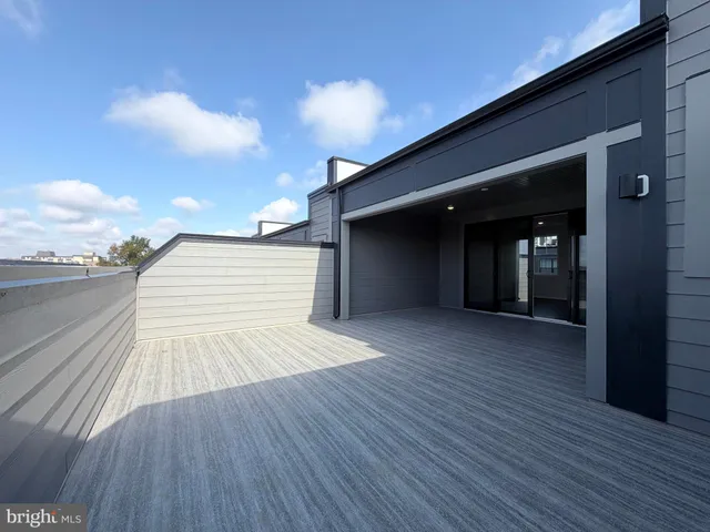 an empty room with wooden floor and balcony