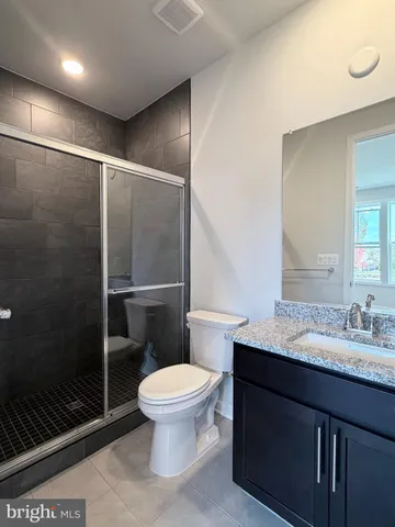 a bathroom with a toilet a sink and shower