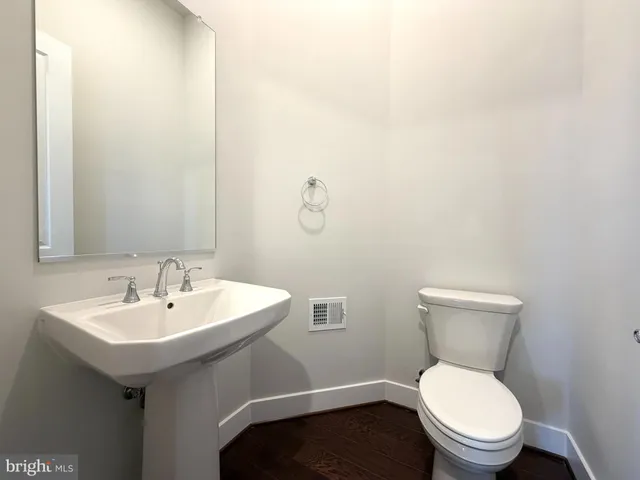a white toilet sitting next to a bathroom sink