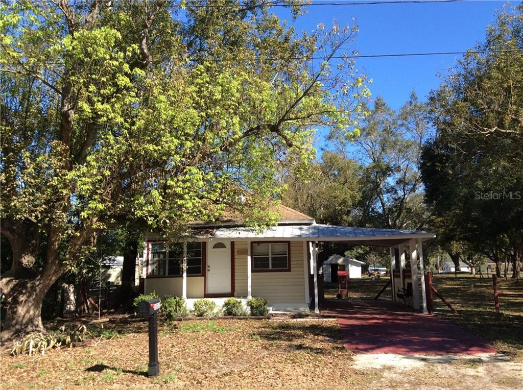 5802 18th Street Zephyrhills, FL 33542 - Photo 1 of 1 a front view of a house with garden