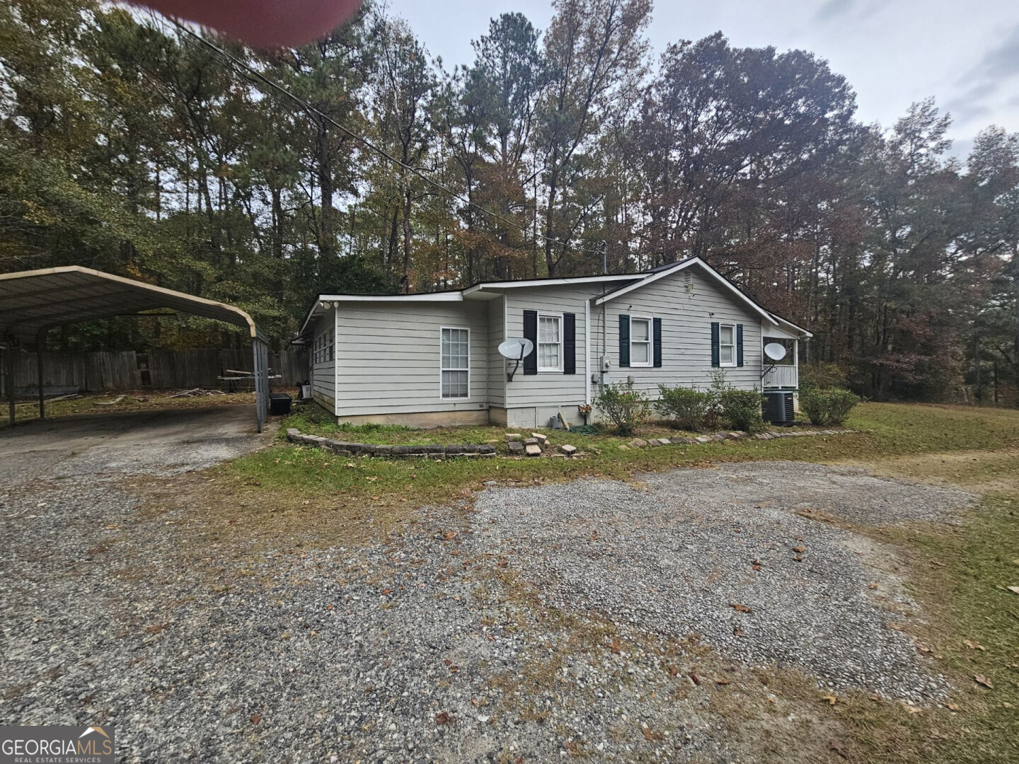 a view of a house with a yard and large tree