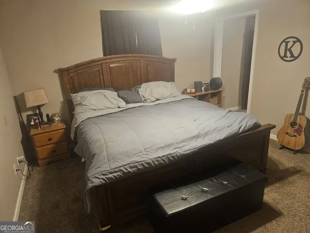 a bed sitting in a bedroom next to a window