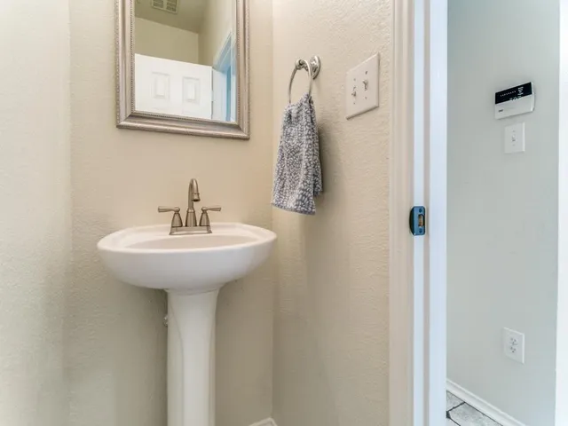 a bathroom with a sink and mirror