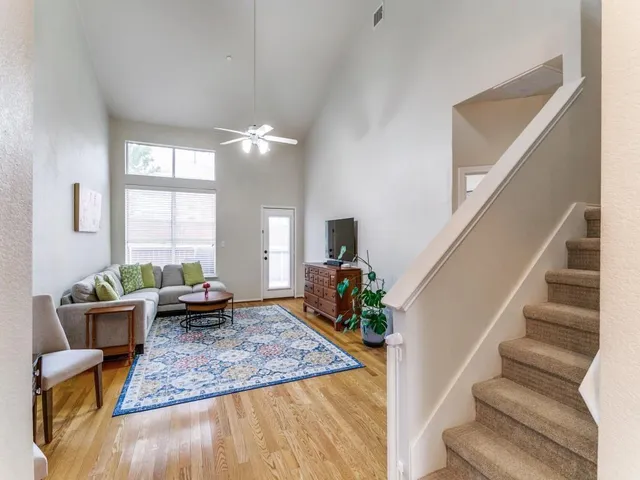 a view of living room filled with furniture hardwood and window