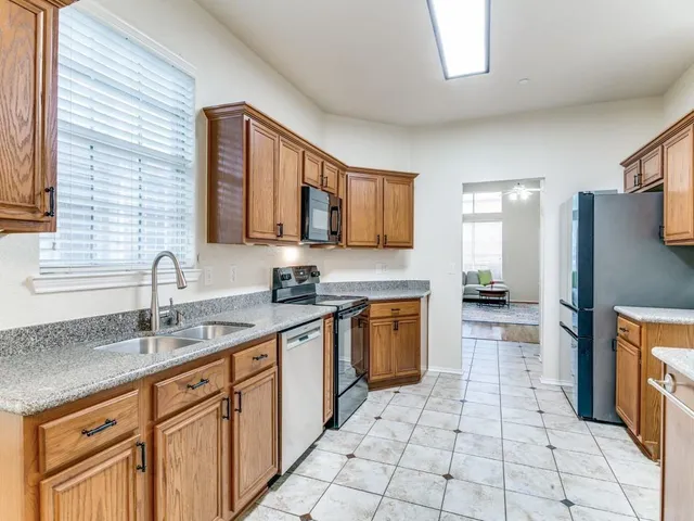 a kitchen with stainless steel appliances granite countertop a sink stove and cabinets