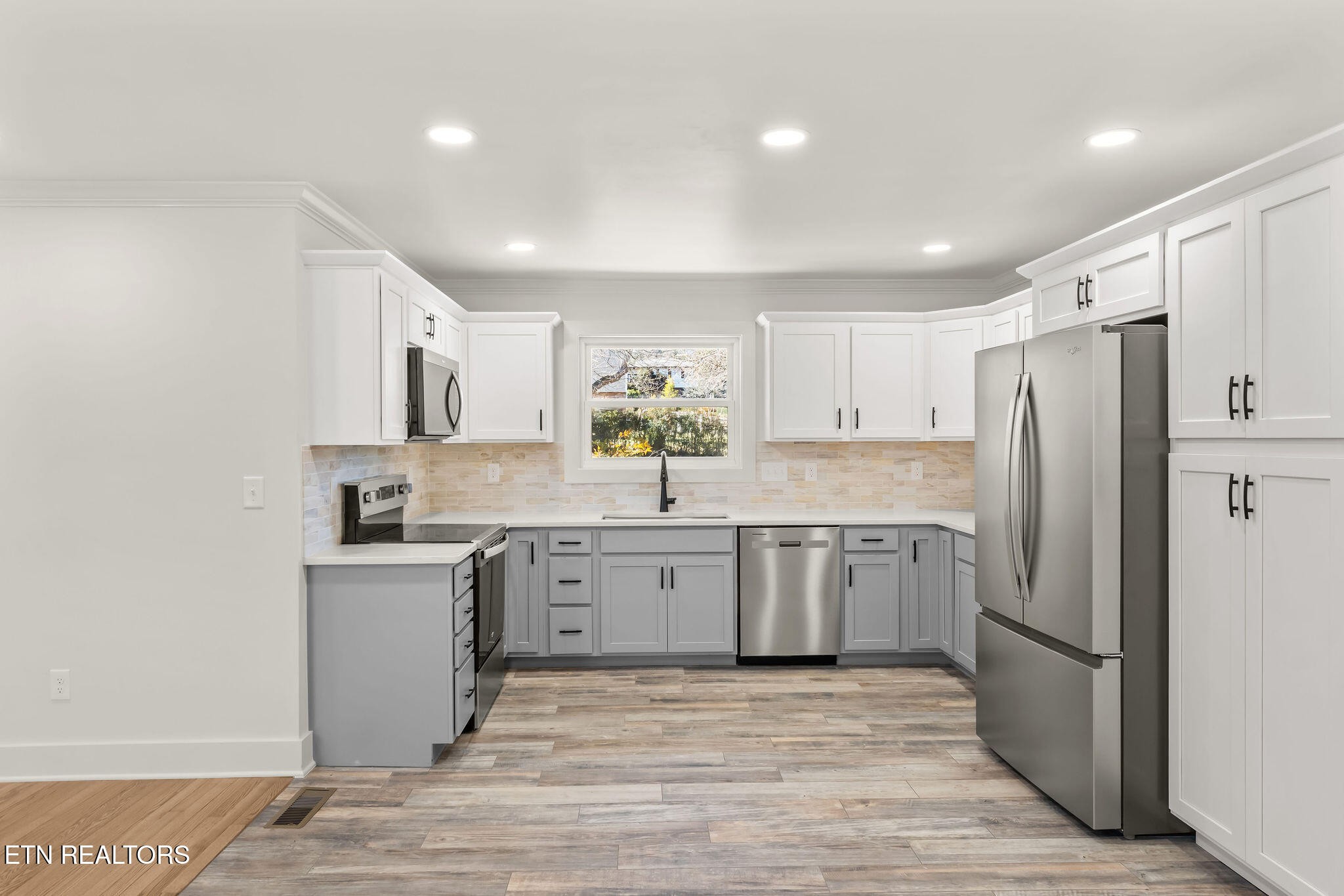 221 Medford Road Knoxville, TN 37922 - Photo 13 of 35 a kitchen with a sink stainless steel appliances and white cabinets