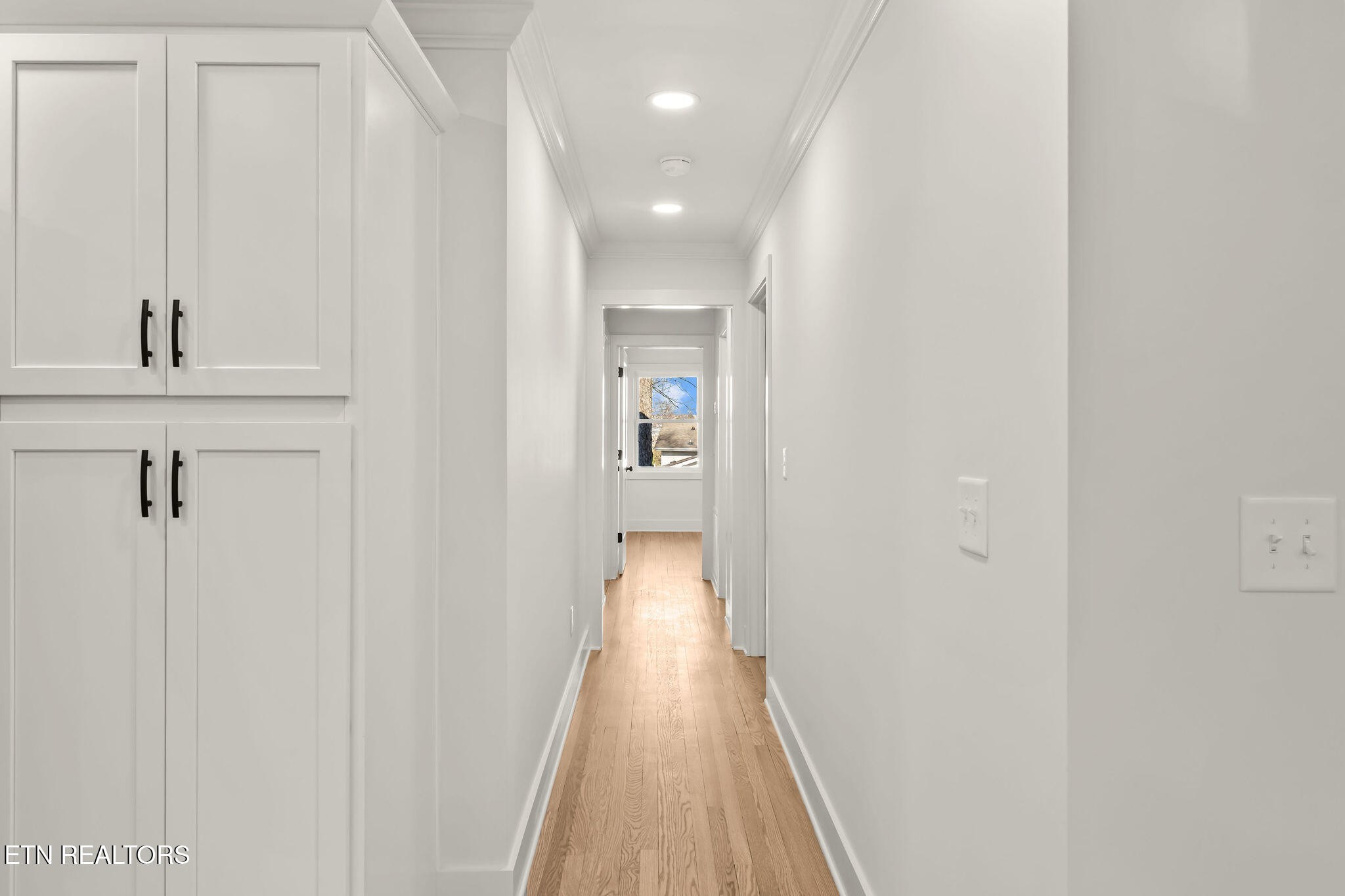 221 Medford Road Knoxville, TN 37922 - Photo 14 of 35 a view of a hallway with wooden floor and a bathroom