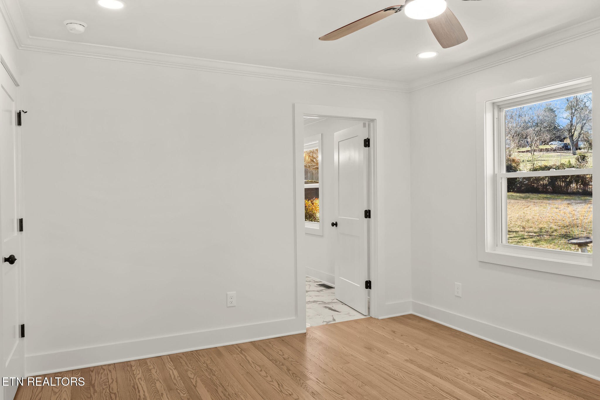221 Medford Road Knoxville, TN 37922 - Photo 15 of 35 an empty room with wooden floor and cabinet