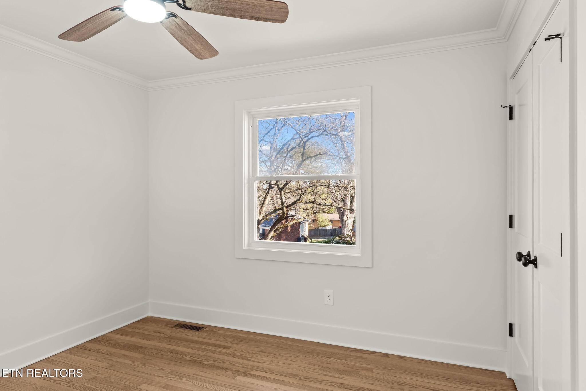 221 Medford Road Knoxville, TN 37922 - Photo 24 of 35 an empty room with a window and wooden floor