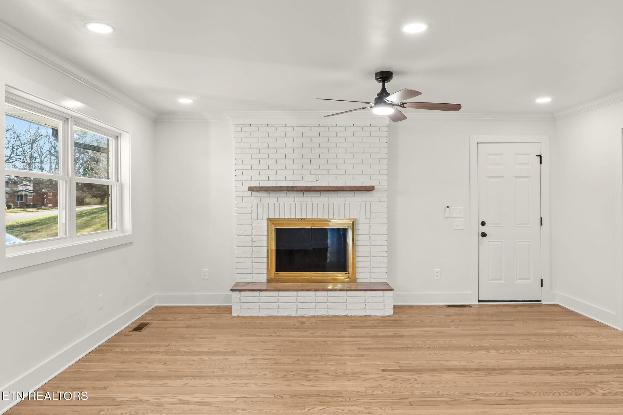 221 Medford Road Knoxville, TN 37922 - Photo 8 of 35 a view of an empty room with a fireplace and a window