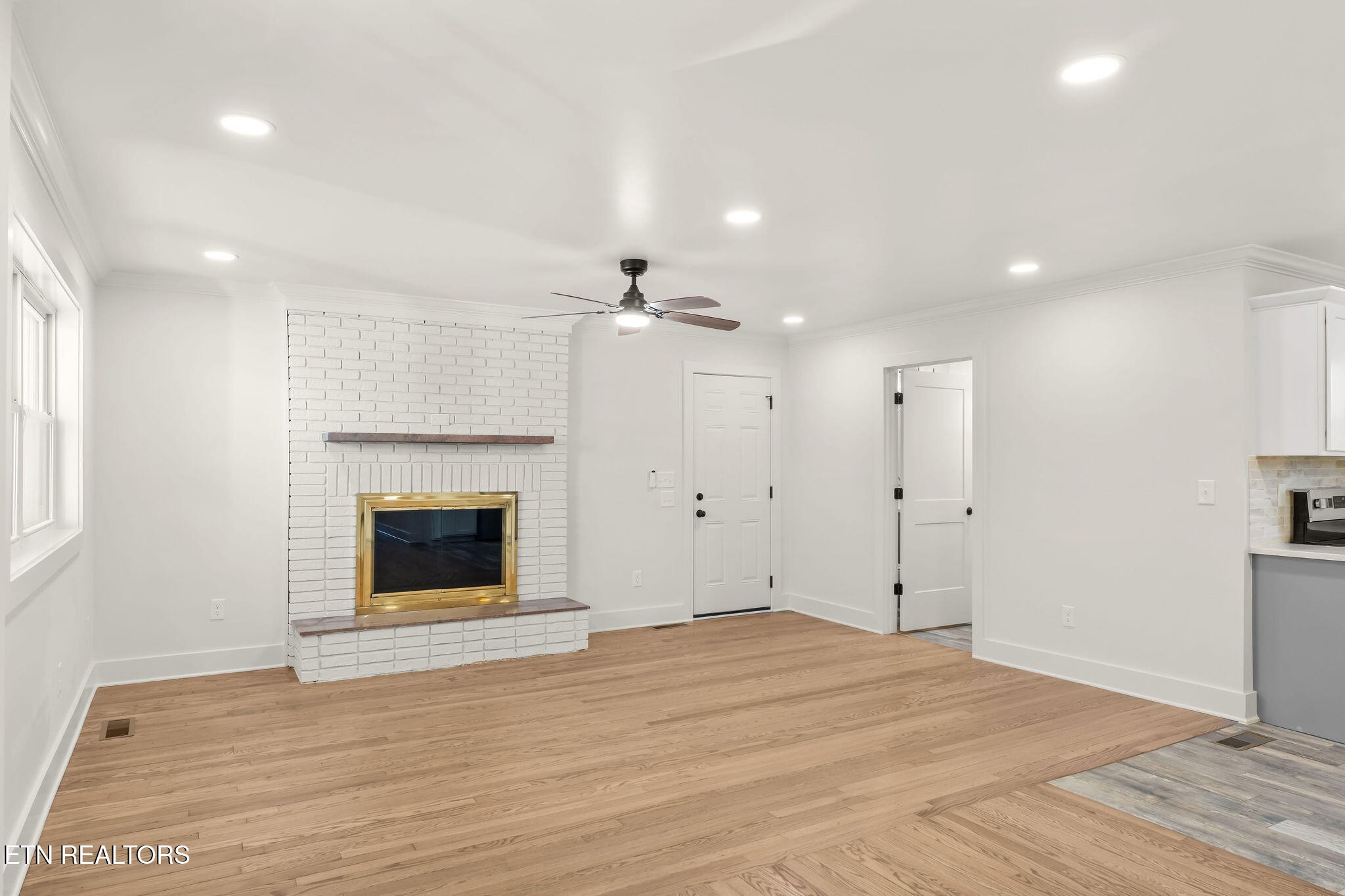 221 Medford Road Knoxville, TN 37922 - Photo 10 of 35 a view of empty room with wooden floor and fireplace