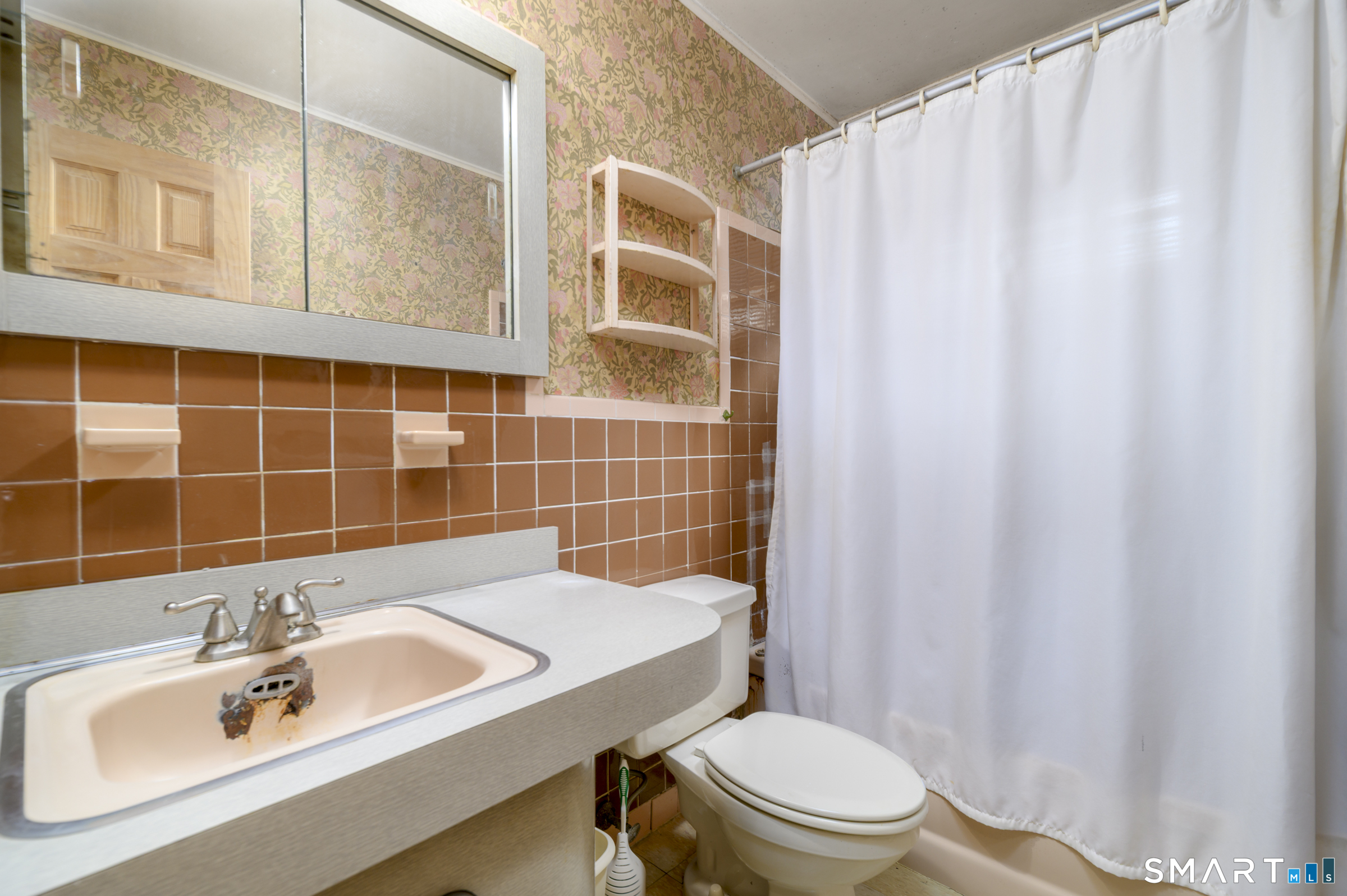 64 Alpine Street Stamford, CT 06905 - Photo 15 of 19 a bathroom with a sink a toilet and shower