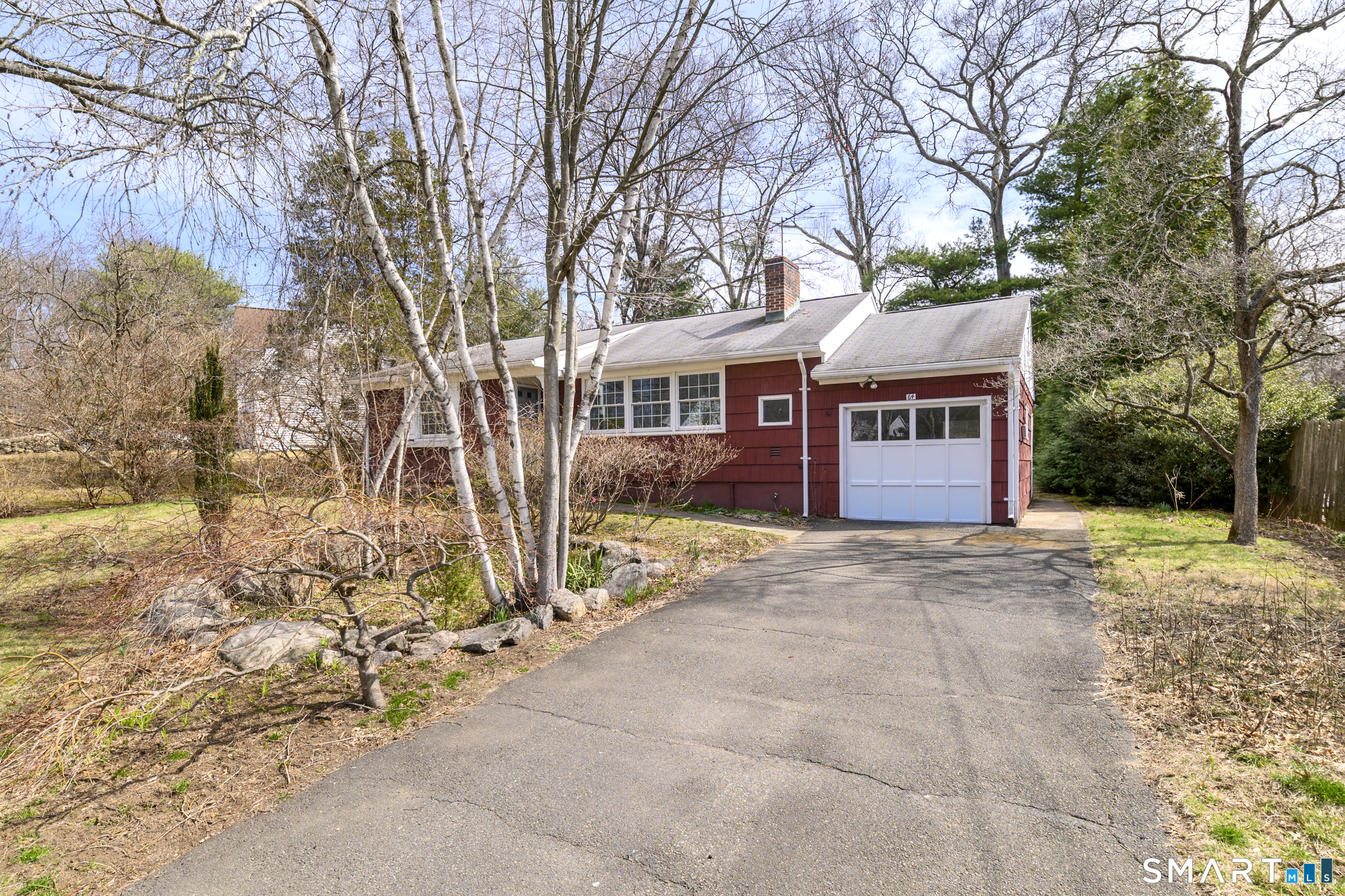 64 Alpine Street Stamford, CT 06905 - Photo 3 of 19 a front view of a house with a yard and garage