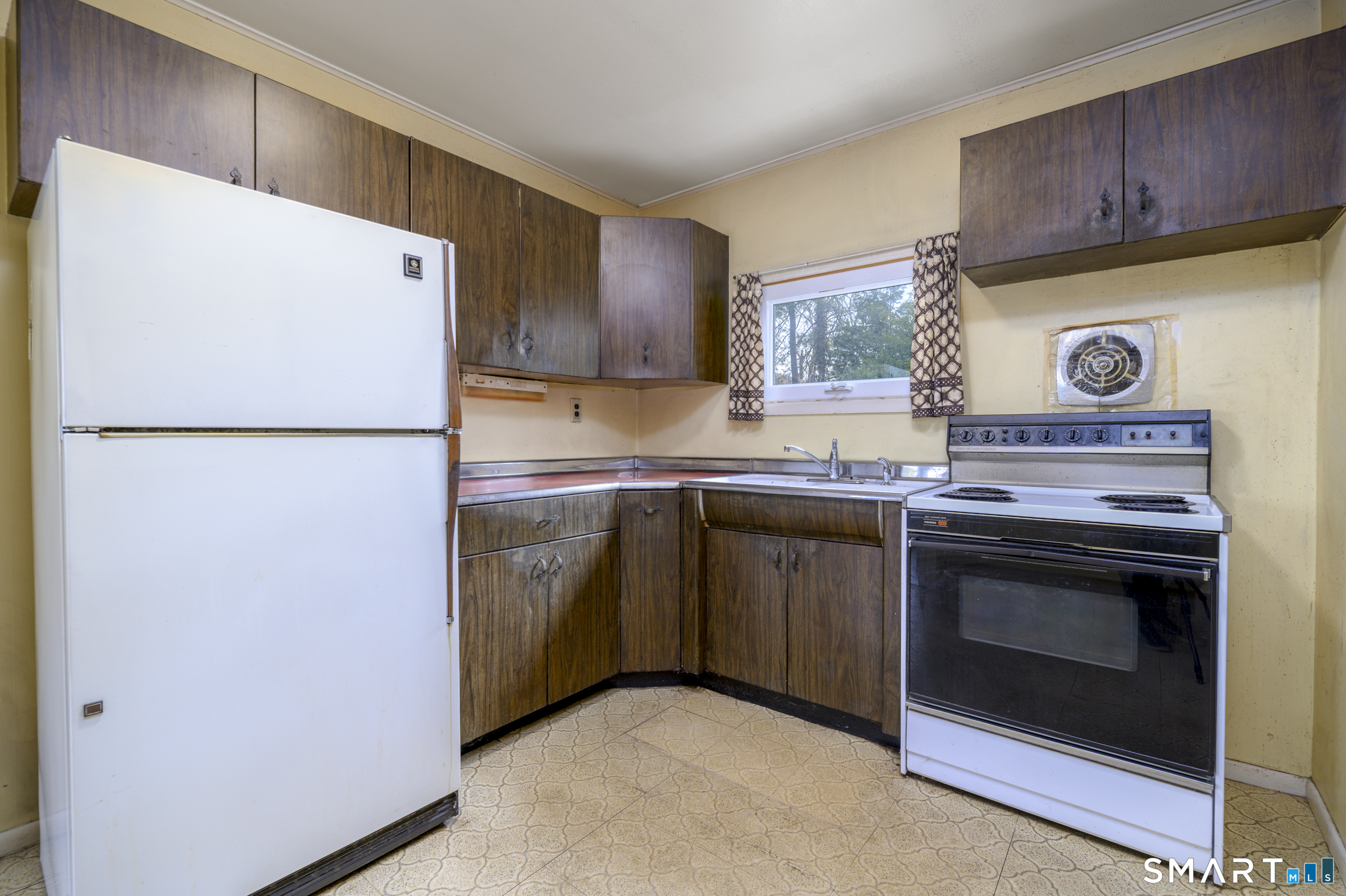 64 Alpine Street Stamford, CT 06905 - Photo 7 of 19 a kitchen with a refrigerator sink and cabinets