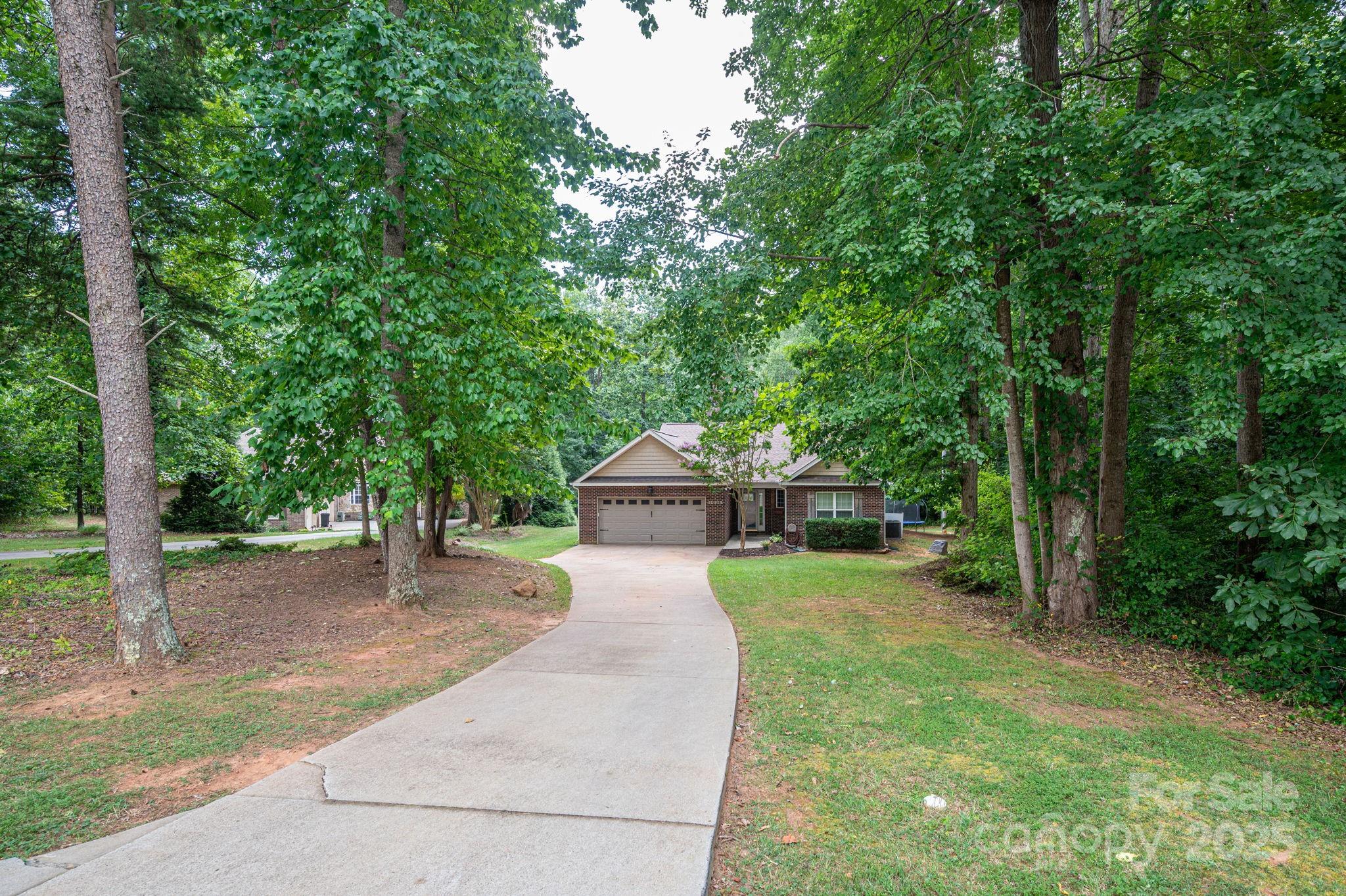1925 Cameron Heights Circle Denver, NC 28037 - Photo 3 of 34 a front view of a house with a yard and trees