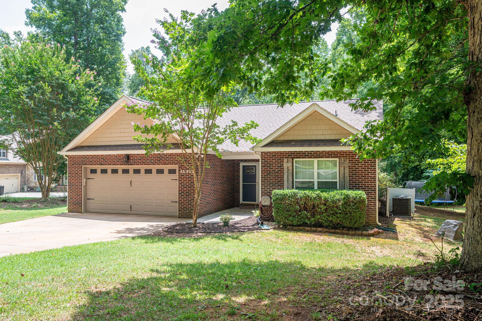 1925 Cameron Heights Circle Denver, NC 28037 - Photo 5 of 34 a front view of a house with a garden