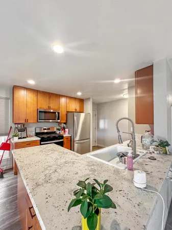 a kitchen with stainless steel appliances kitchen island granite countertop a sink and cabinets