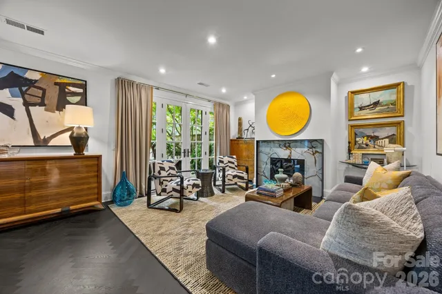 a living room with furniture a fireplace with garden view