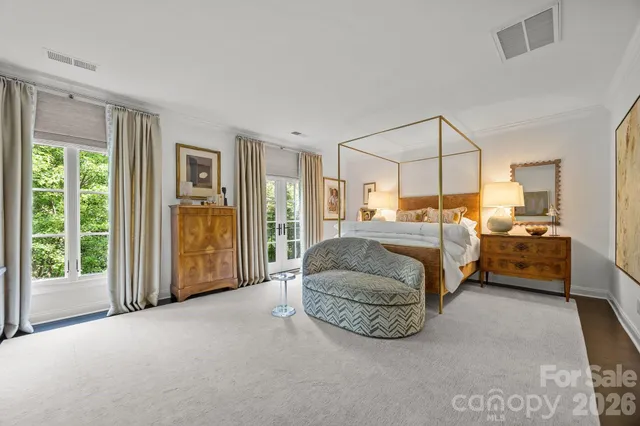 a bedroom with bed and glass door