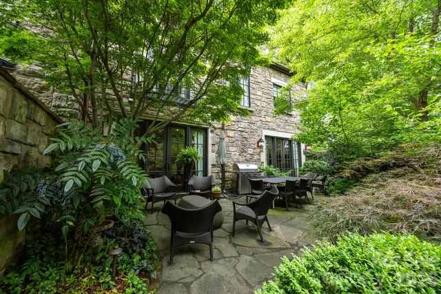 a view of a house with backyard and sitting area
