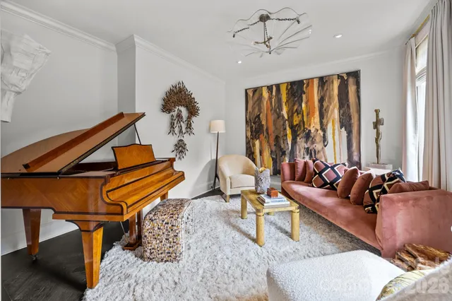 a living room with furniture a rug and a window