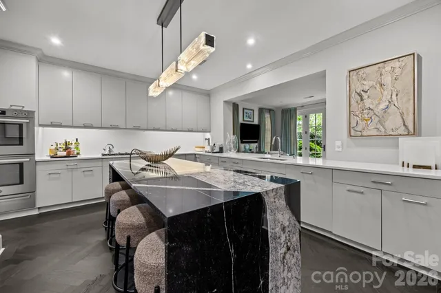 a kitchen with a table chairs sink and cabinets