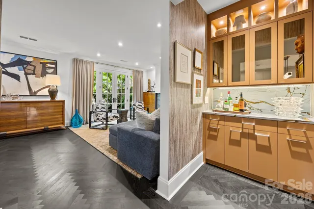 a living room with stainless steel appliances granite countertop furniture and a kitchen view
