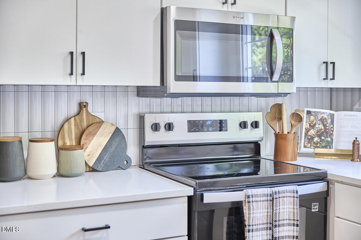 2613 McNeil Street, Unit E Raleigh, NC 27608 - Photo 13 of 28 a kitchen with a stove and cabinets