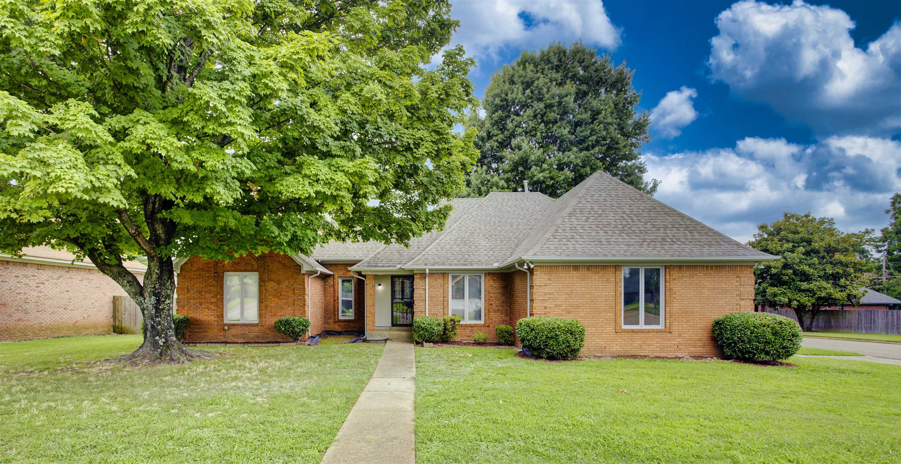 5259 Ross Road Memphis, TN 38141 - Photo 1 of 17 a front view of a house with a yard