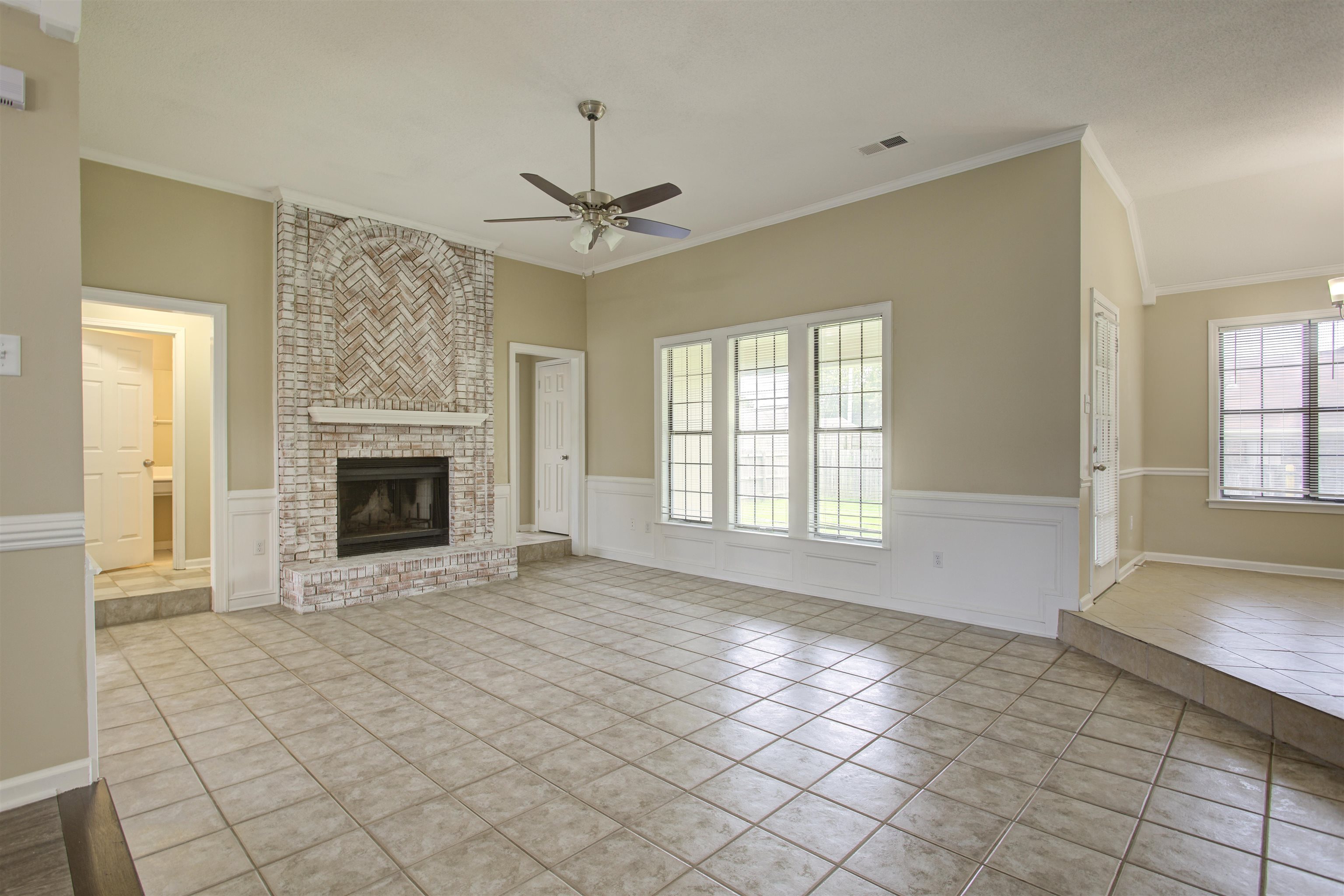 5259 Ross Road Memphis, TN 38141 - Photo 12 of 17 an empty room with windows and fireplace