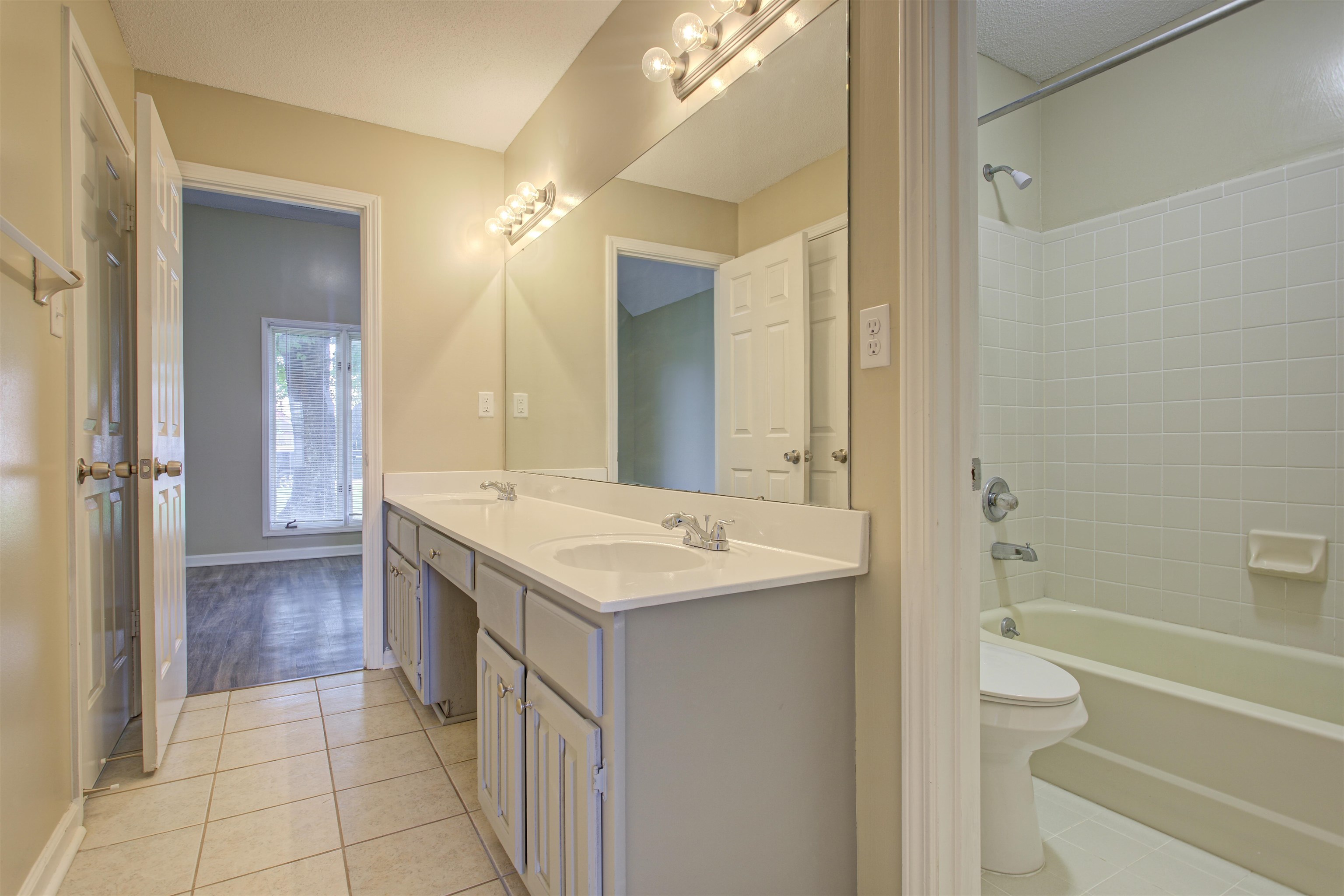 5259 Ross Road Memphis, TN 38141 - Photo 14 of 17 a bathroom with a granite countertop sink a toilet and shower