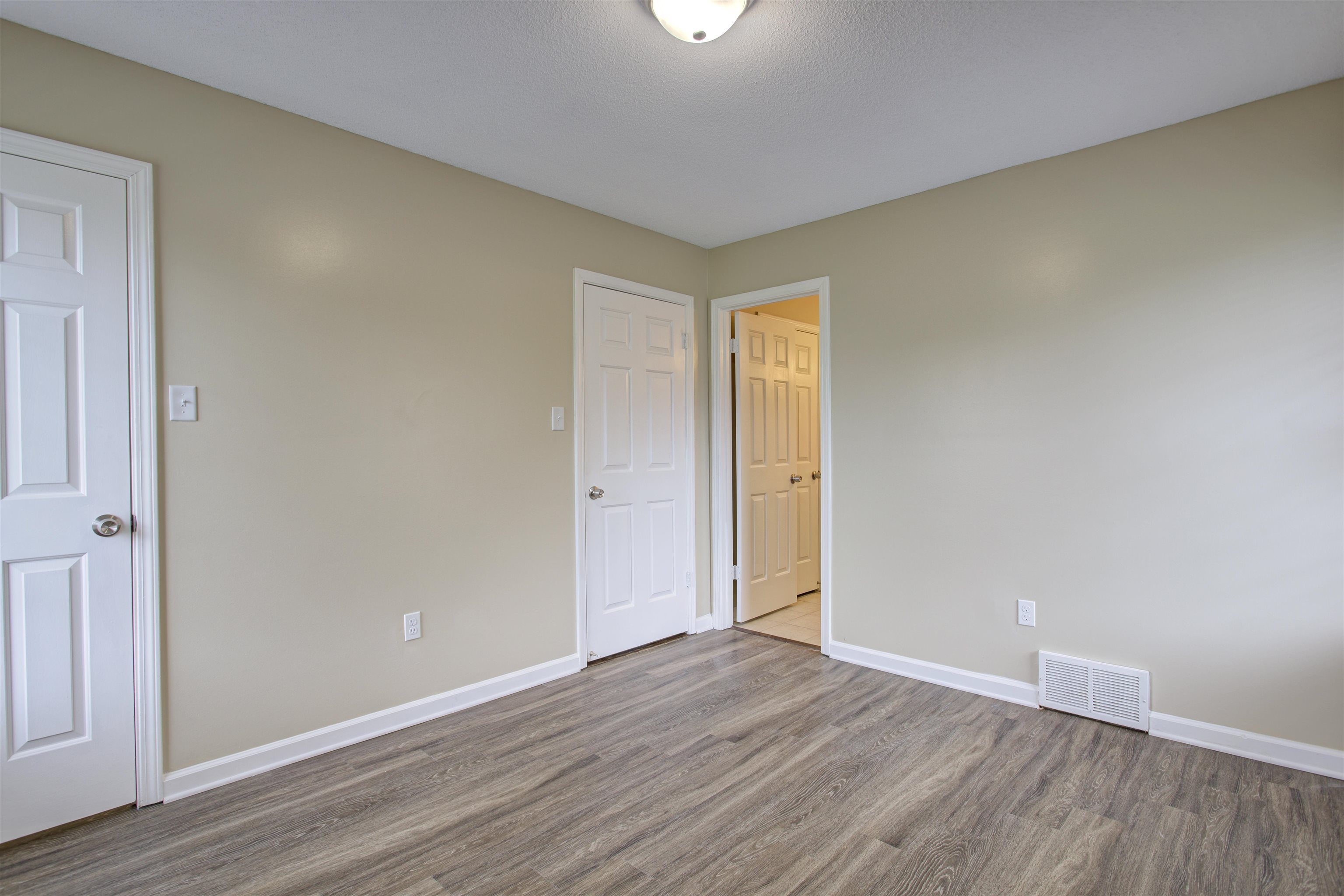 5259 Ross Road Memphis, TN 38141 - Photo 15 of 17 a view of an empty room with wooden floor