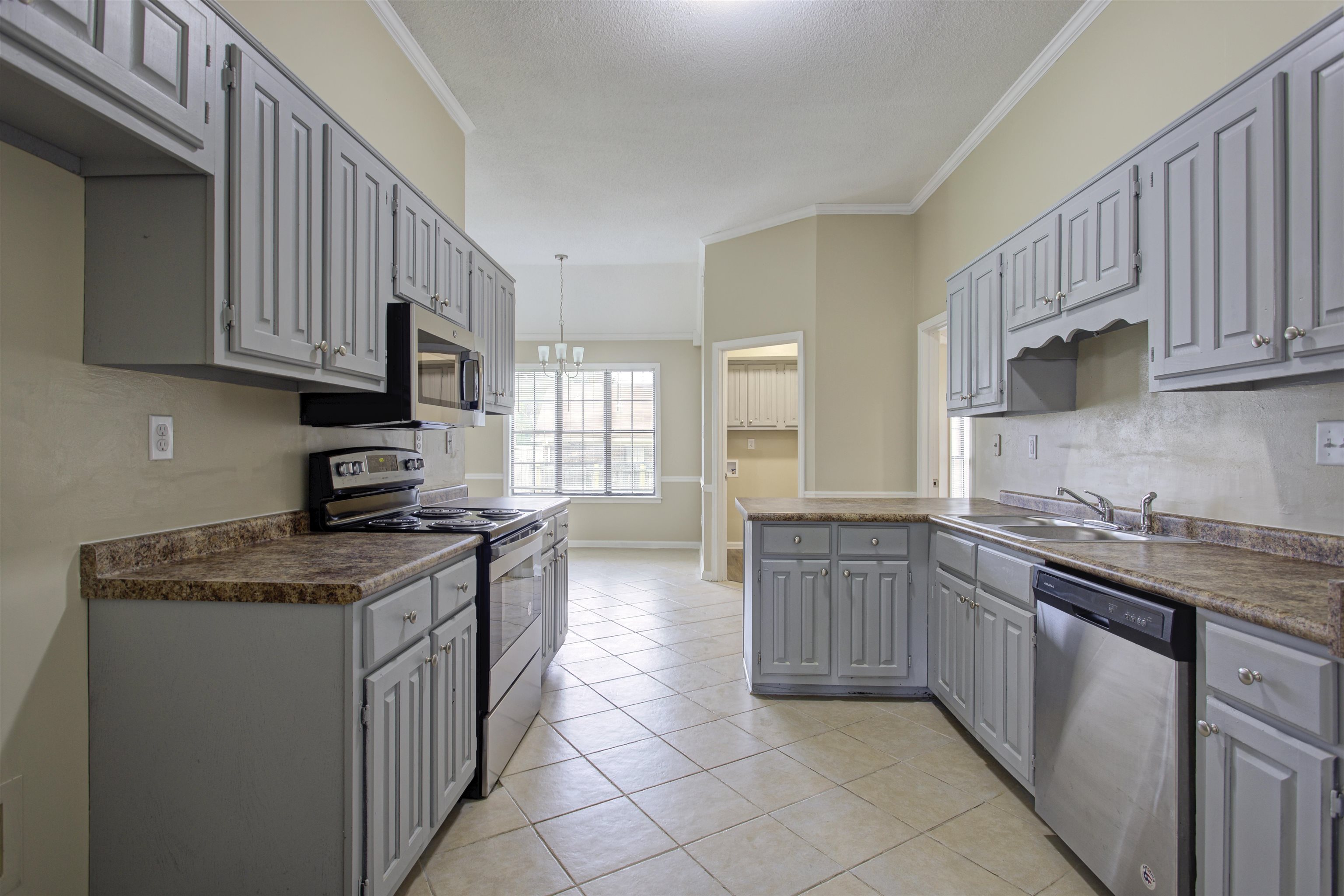 5259 Ross Road Memphis, TN 38141 - Photo 5 of 17 a kitchen with stainless steel appliances granite countertop a sink stove and cabinets