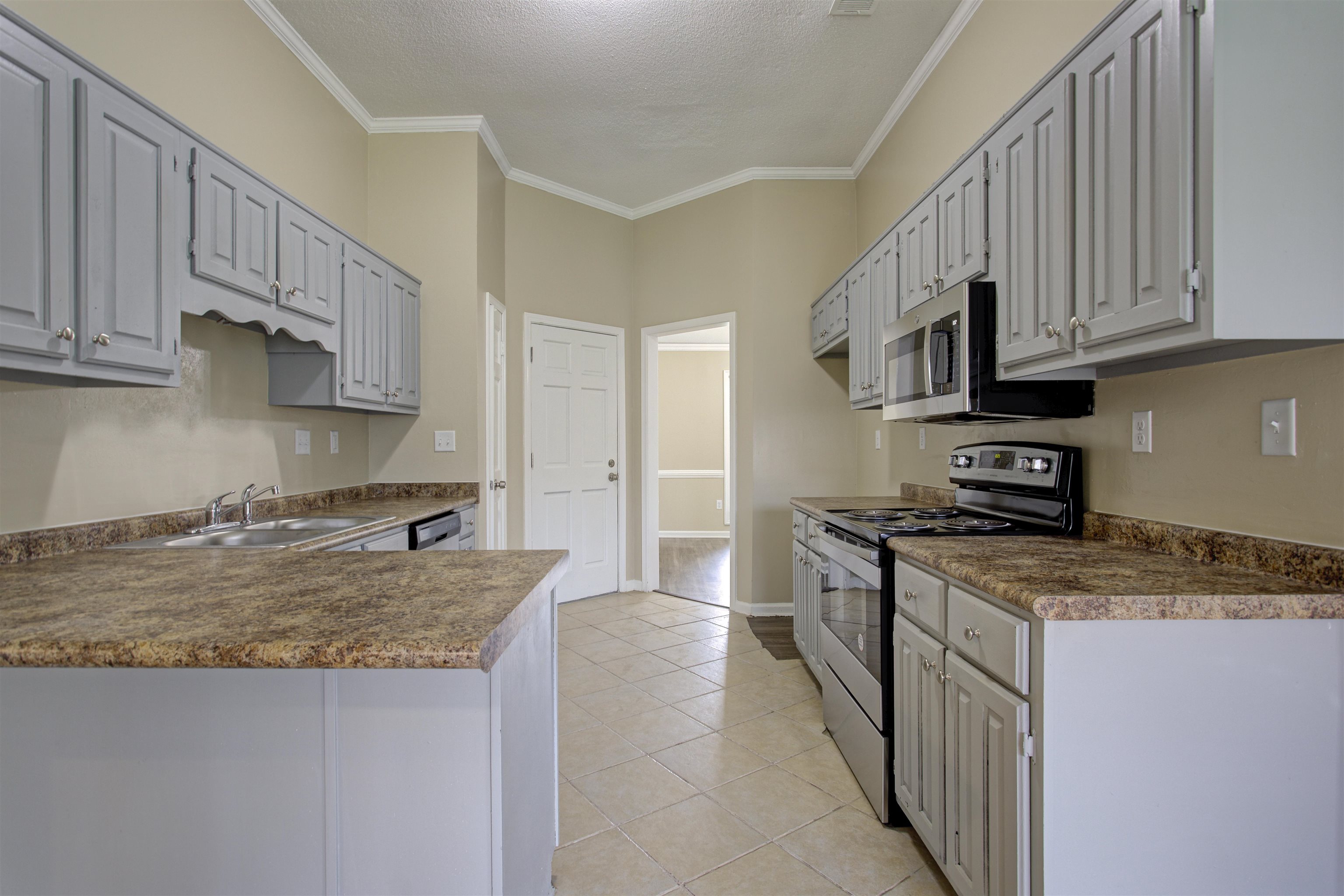 5259 Ross Road Memphis, TN 38141 - Photo 6 of 17 a kitchen with stainless steel appliances granite countertop a stove a sink and a refrigerator