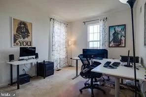 a view of a workspace with furniture and a window