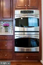 a stove top oven sitting inside of a kitchen