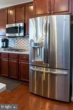 a kitchen with granite countertop a stove and a microwave