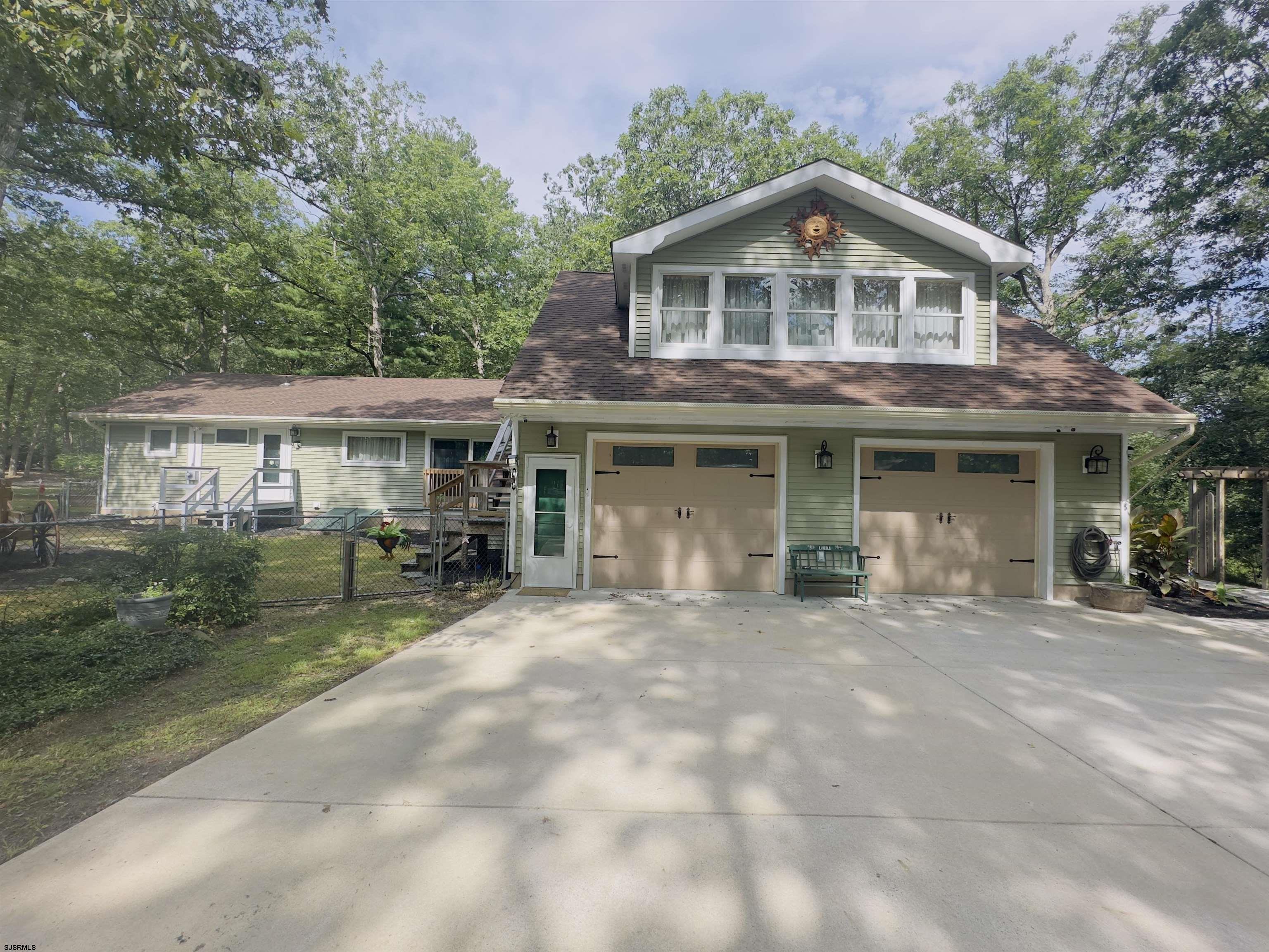 a front view of a house with a garden and porch