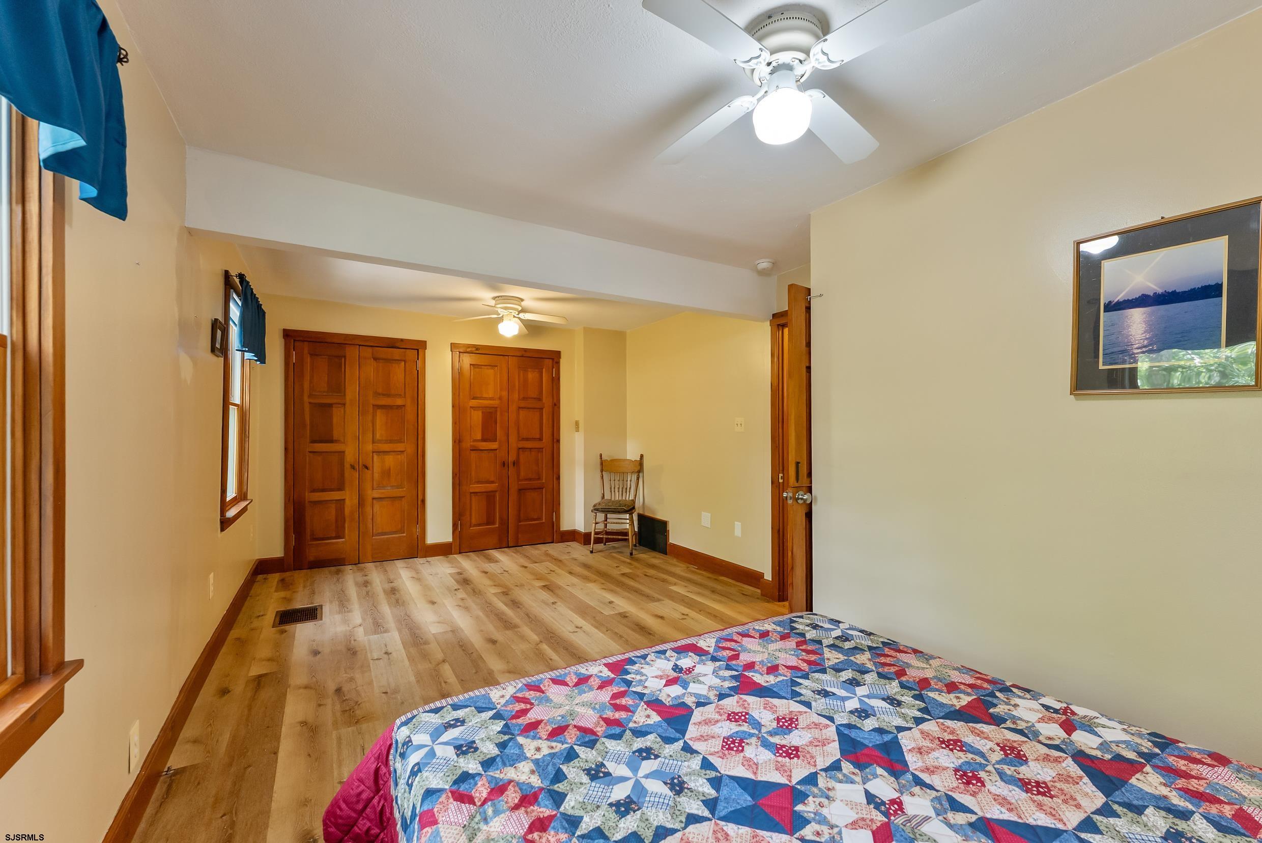 2015 High Bank Road Mays Landing, NJ 08330 - Photo 29 of 89 a bedroom with a bed and a chandelier