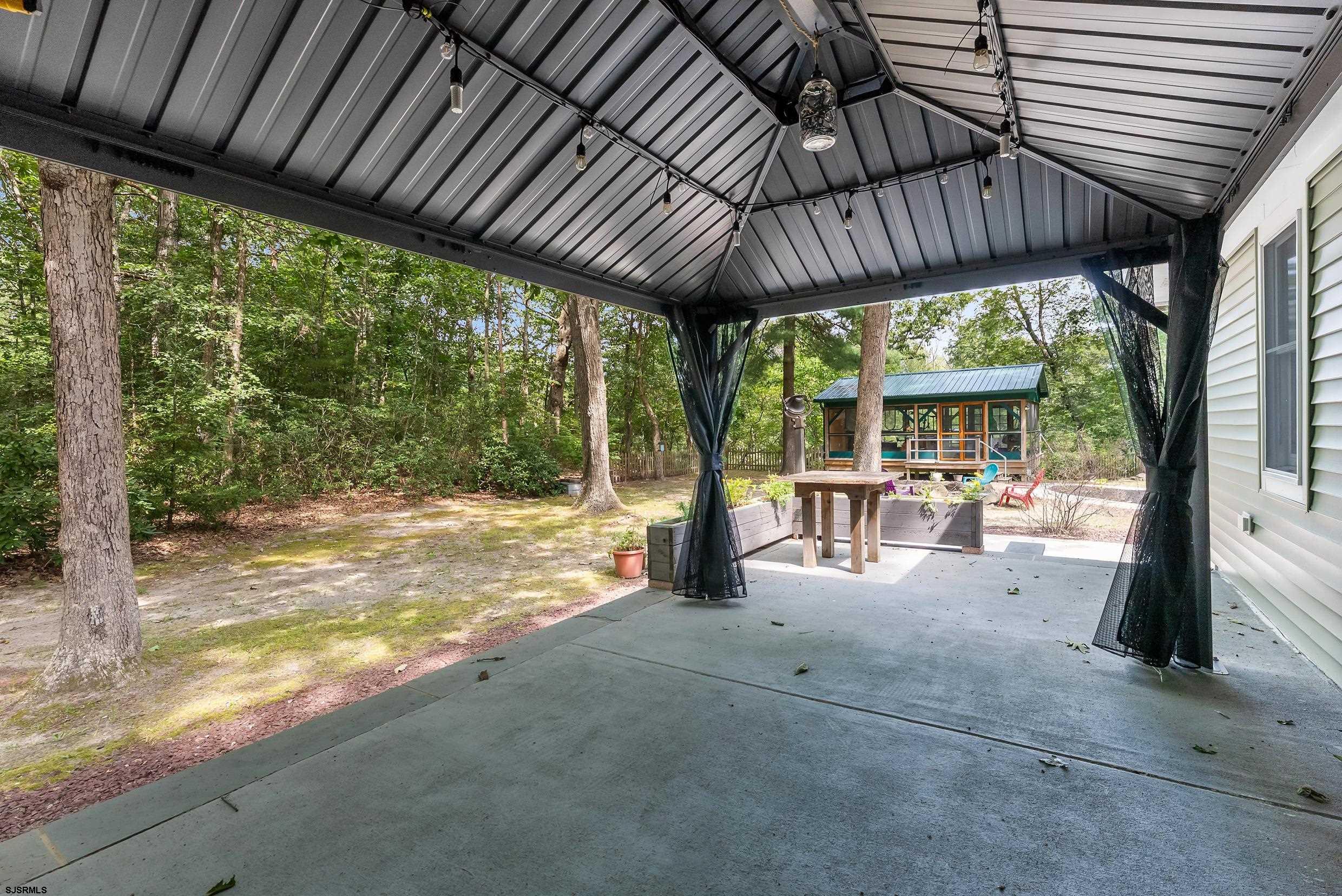 2015 High Bank Road Mays Landing, NJ 08330 - Photo 55 of 89 a view of a patio with table and chairs under a large umbrella