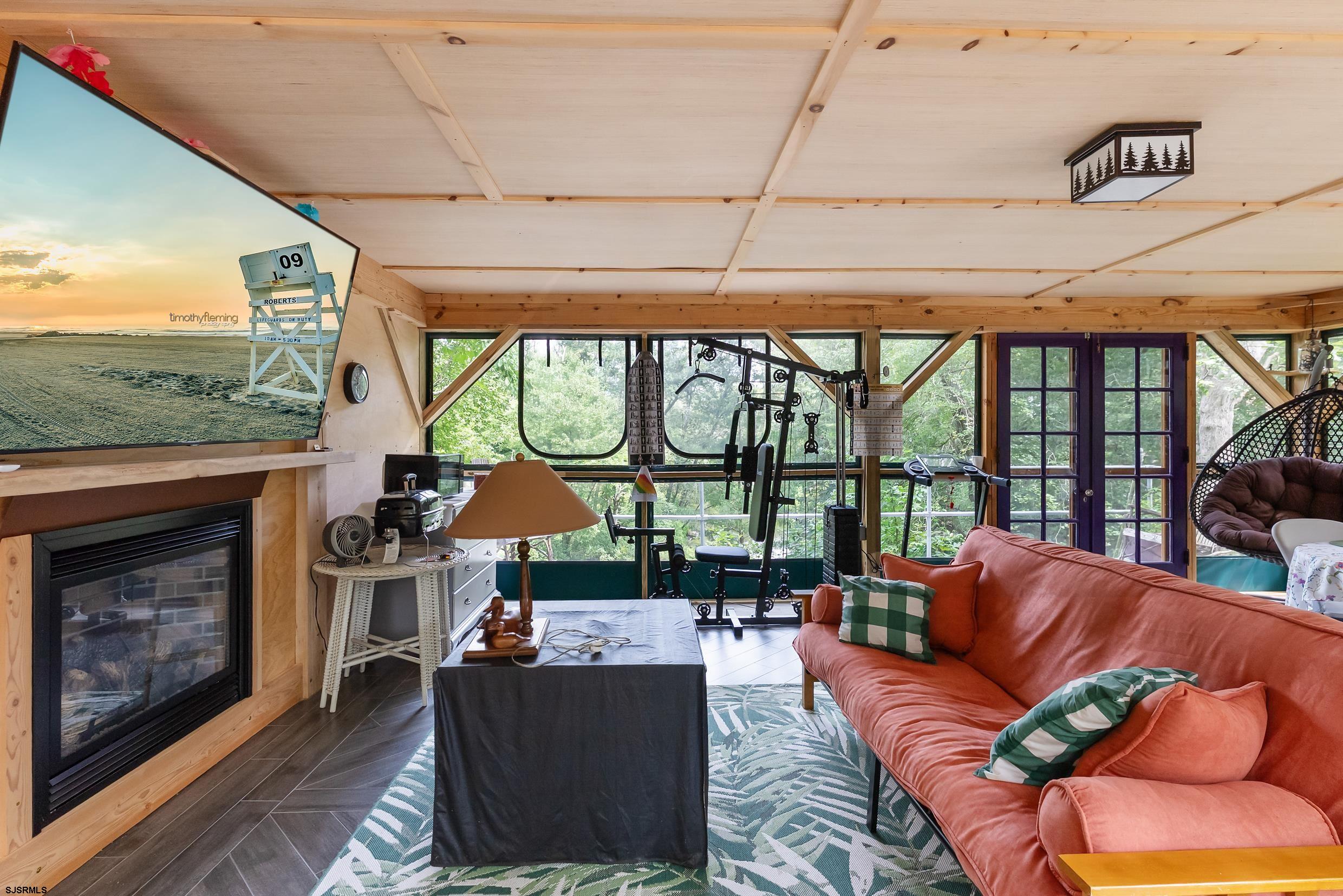 2015 High Bank Road Mays Landing, NJ 08330 - Photo 62 of 89 a living room with furniture a fireplace and a floor to ceiling window