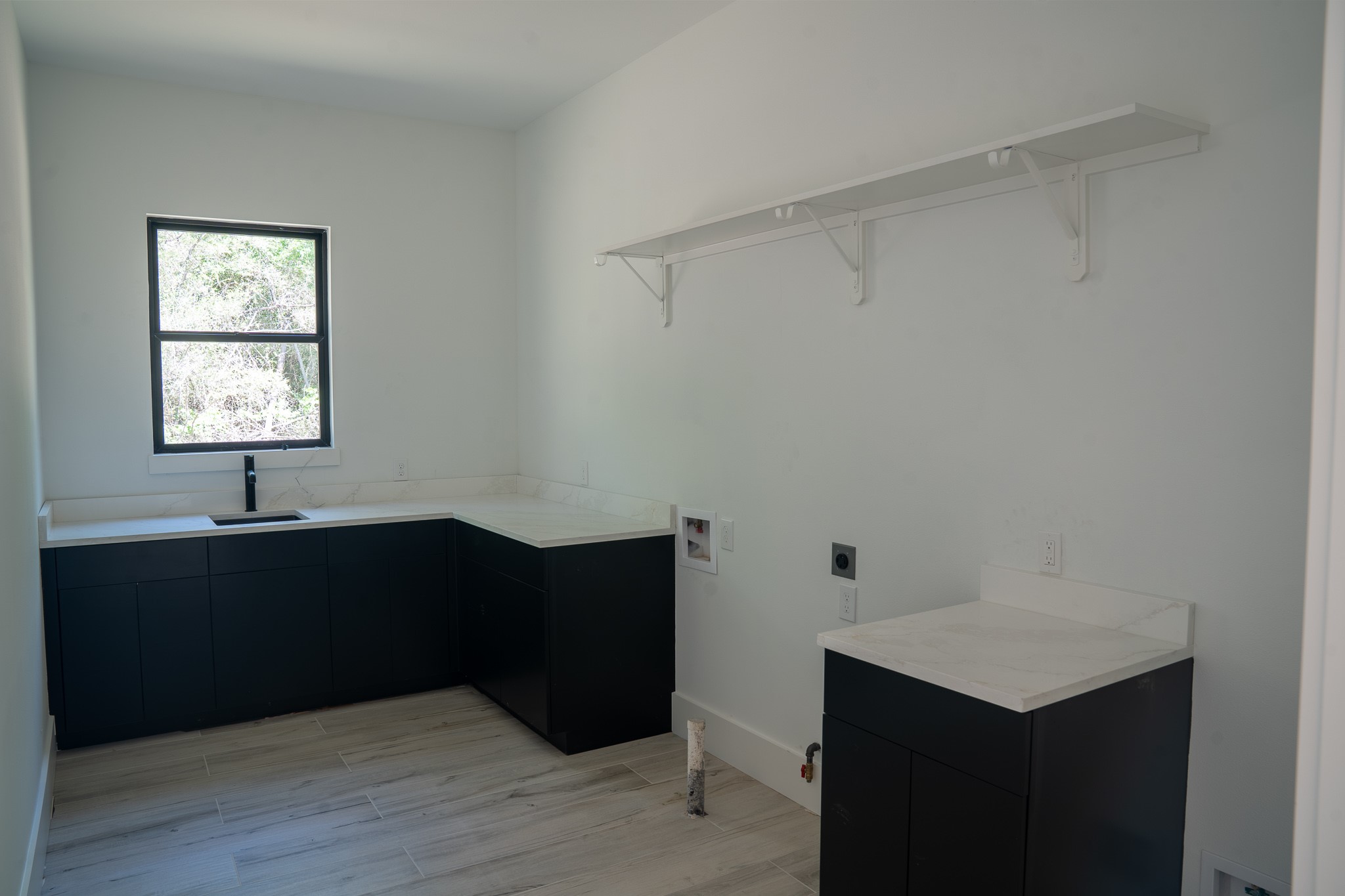 343 Sundog Road Huntsville, TX 77340 - Photo 30 of 37 Laundry room featuring ample storage space and a sink.