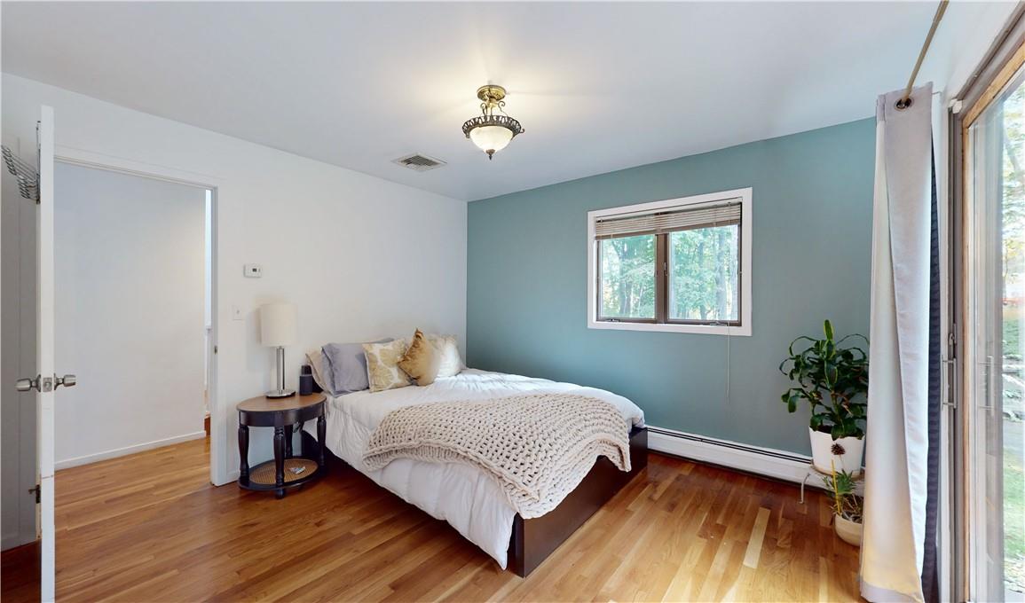 96 Old Pascack Road Pearl River, NY 10965 - Photo 13 of 36 a bedroom with a bed and wooden floor