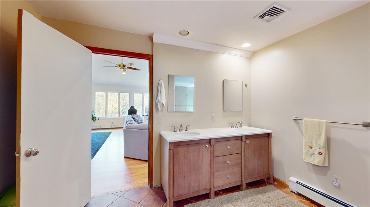 96 Old Pascack Road Pearl River, NY 10965 - Photo 19 of 36 a spacious bathroom with a double vanity sink and mirror