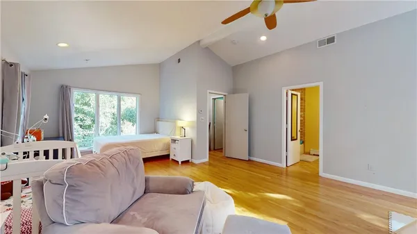 a bedroom with a bed furniture and a window