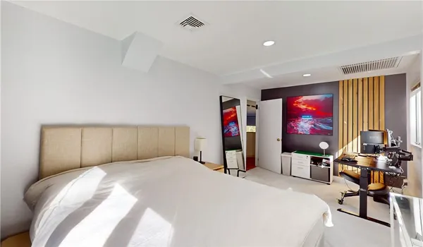 a bedroom with a bed and glass windows